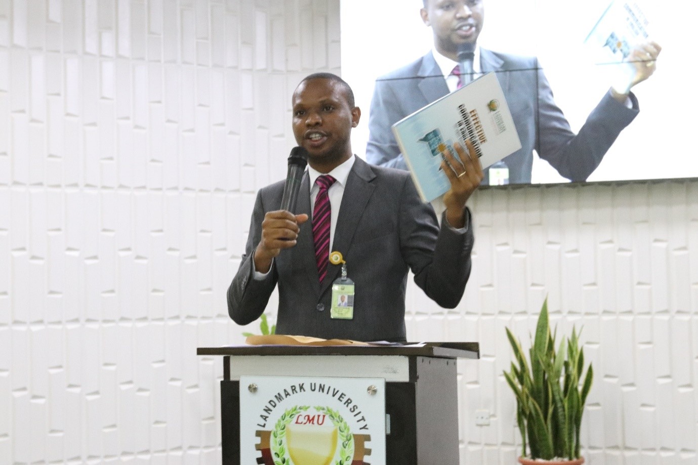 The Registrar, Dr Azubuike Ezenwoke introducing the University publication packaged by the University Wide Courses (UWC) titled, Effective Communication in English Language during Announcement at the 2017/2018 Academic Session Omega Semester Staff Welcome Assembly