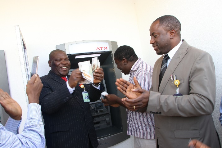 The Vice-Chancellor, Professor Adeniyi Olanyanju displaying the first cash withdrawal at the ATM Gallery